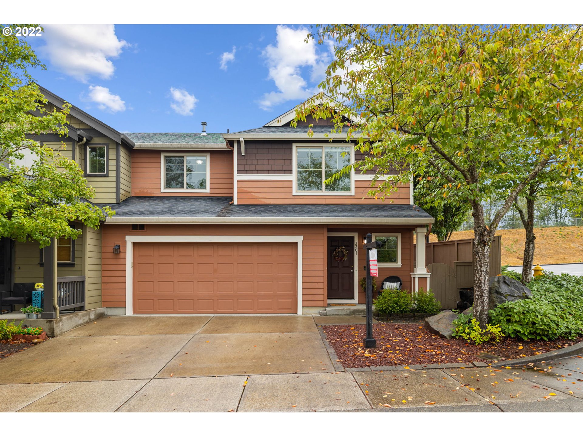 a front view of a house with a yard and garage