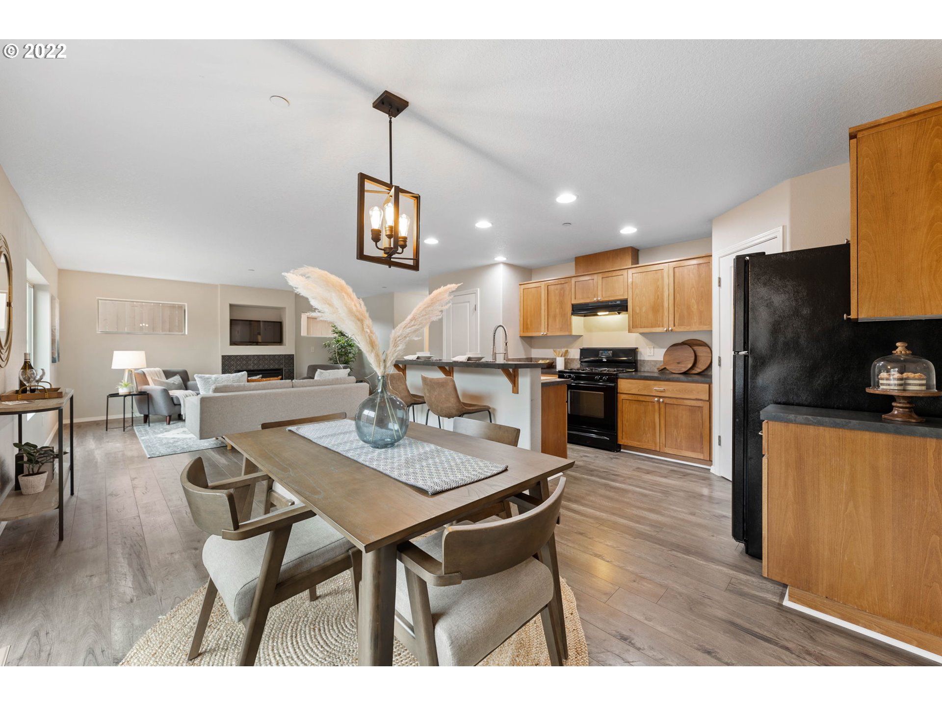 3301 Northwest 47th Drive Camas, WA 98607 - Photo 11 of 32 a open kitchen with stainless steel appliances kitchen island granite countertop a table chairs refrigerator and a sink