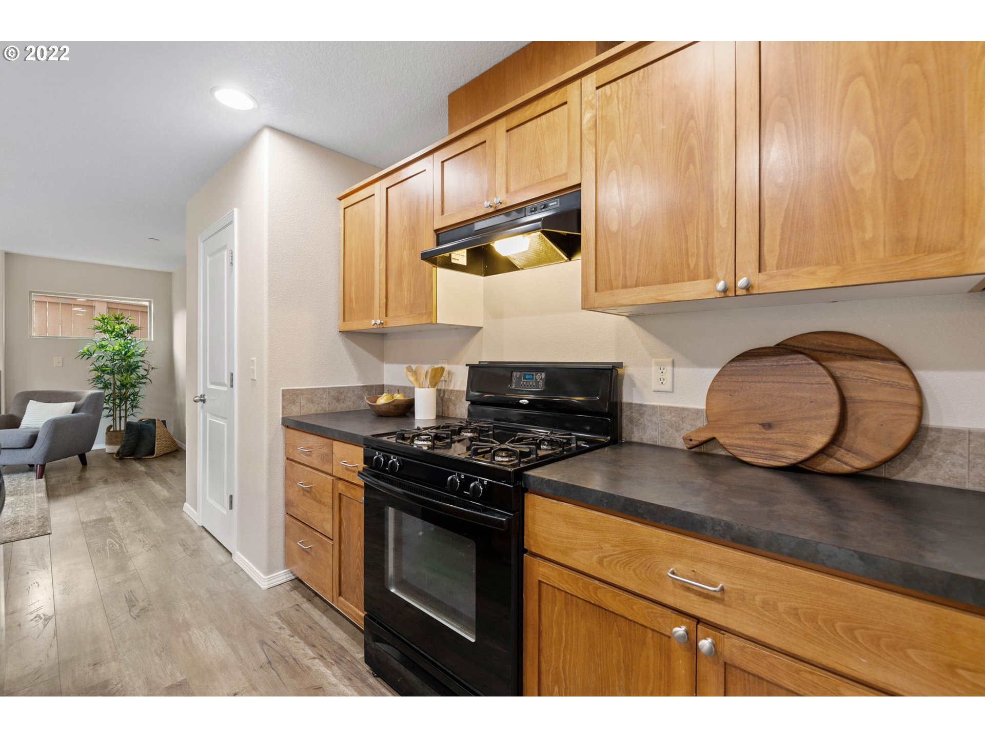 3301 Northwest 47th Drive Camas, WA 98607 - Photo 12 of 32 a kitchen with granite countertop wooden cabinets and a stove top oven