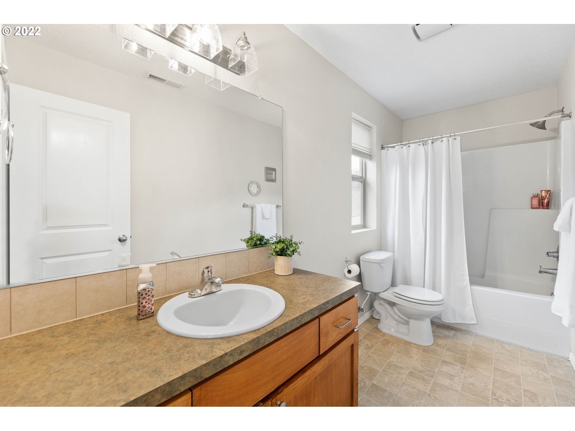 3301 Northwest 47th Drive Camas, WA 98607 - Photo 20 of 32 a bathroom with a sink a toilet a mirror and shower