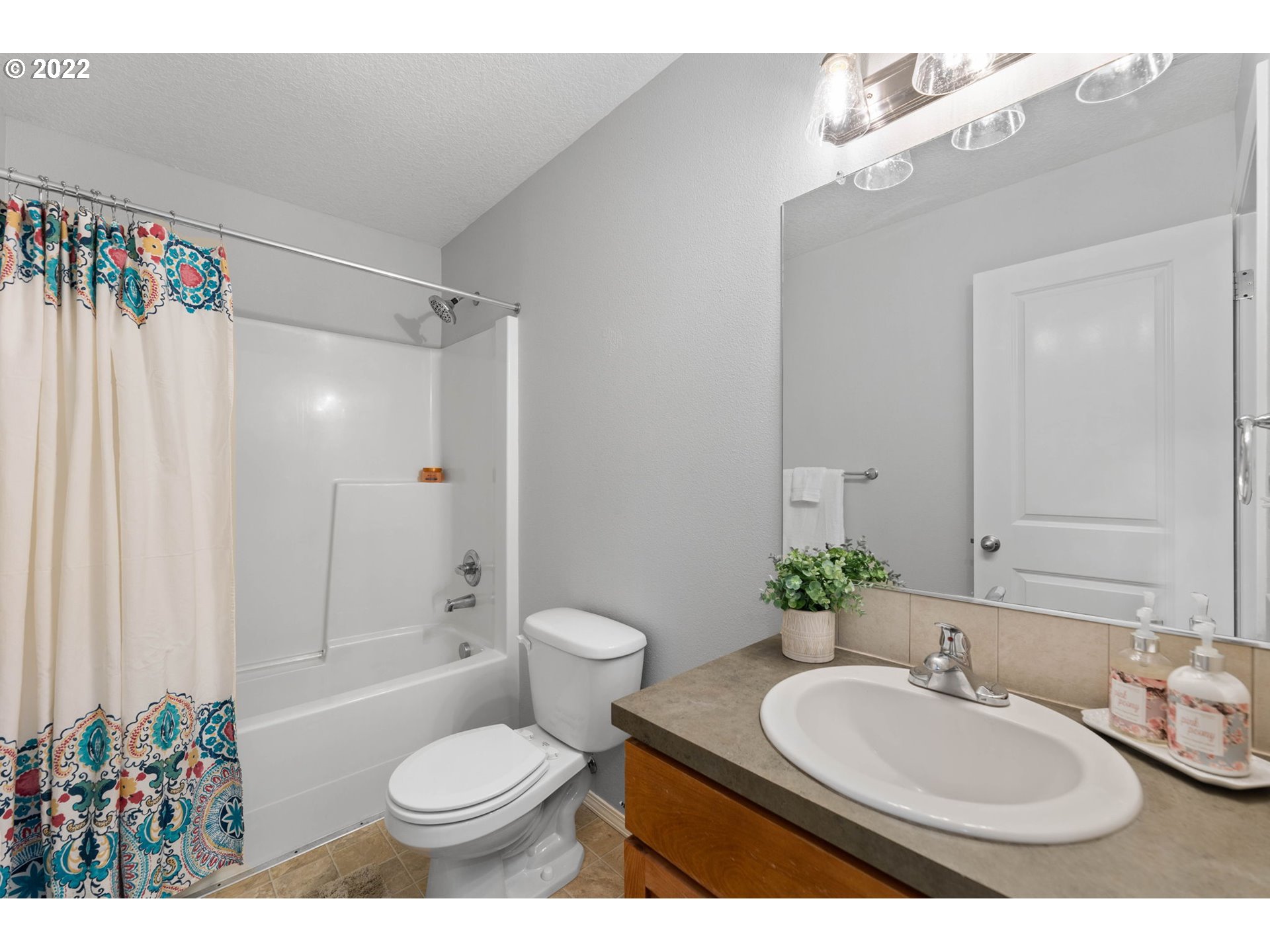 3301 Northwest 47th Drive Camas, WA 98607 - Photo 27 of 32 a bathroom with a sink toilet a mirror and shower