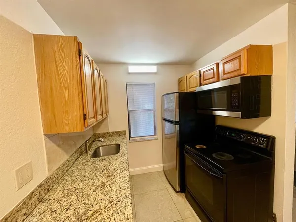 a kitchen with a refrigerator and a sink