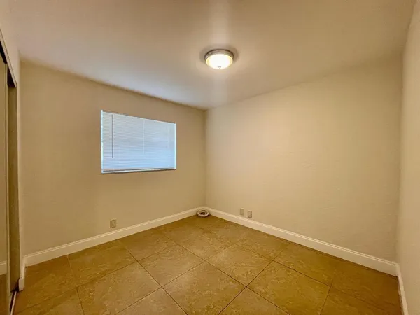 an empty room with a empty space and a window