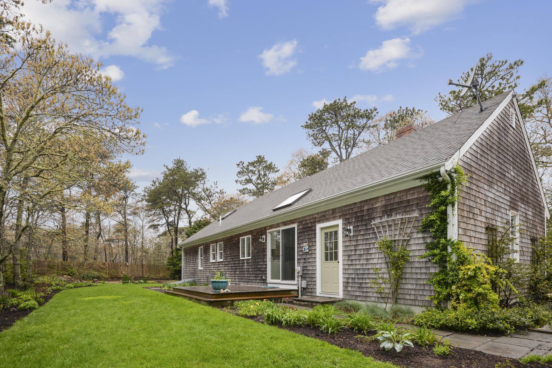 11 Quanset Road Orleans, MA 02653 - Photo 4 of 27 a front view of a house with a garden and yard