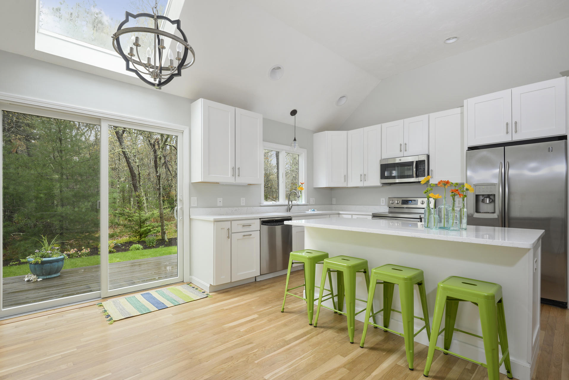 11 Quanset Road Orleans, MA 02653 - Photo 7 of 27 a open kitchen with granite countertop a stove a sink dishwasher a stove a refrigerator with a dining table and chairs with wooden floor
