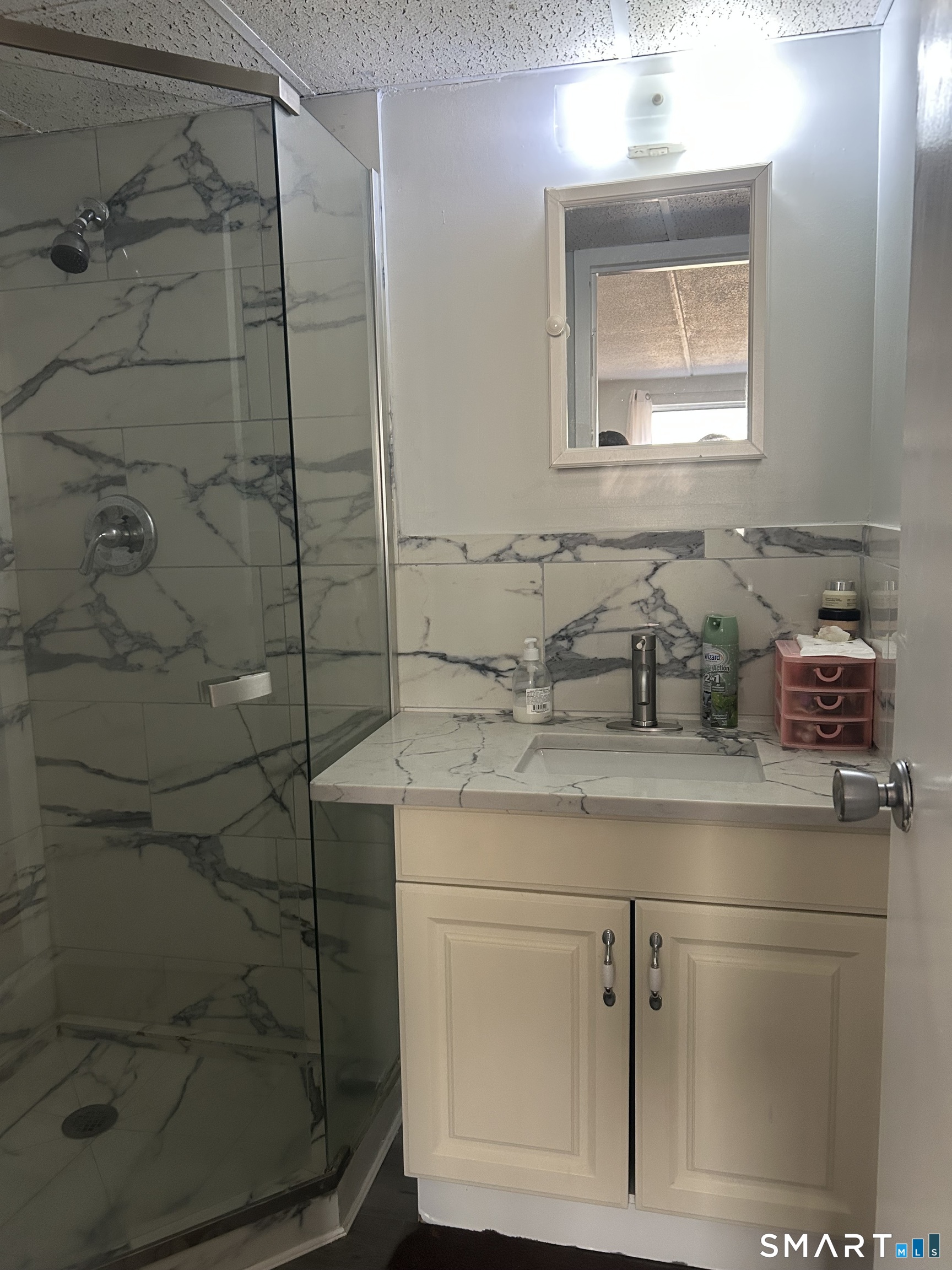 126 Triangle Street, Unit B13 Danbury, CT 06810 - Photo 14 of 20 a bathroom with a granite countertop sink a mirror and shower