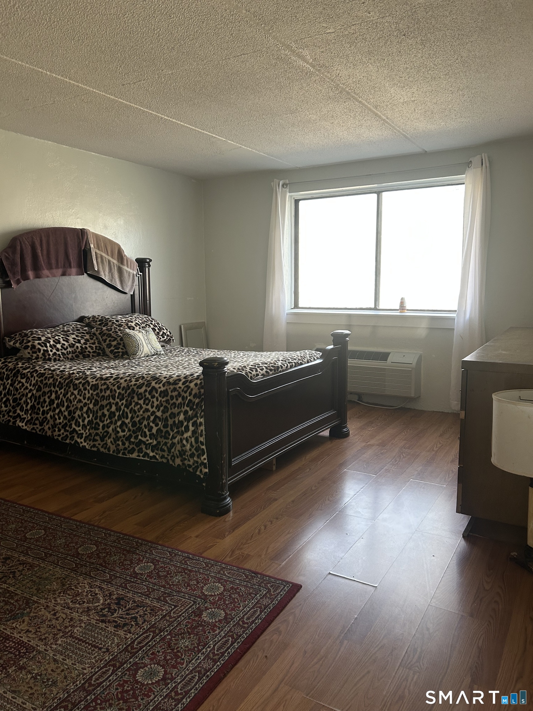 126 Triangle Street, Unit B13 Danbury, CT 06810 - Photo 15 of 20 a bedroom with a bed and window