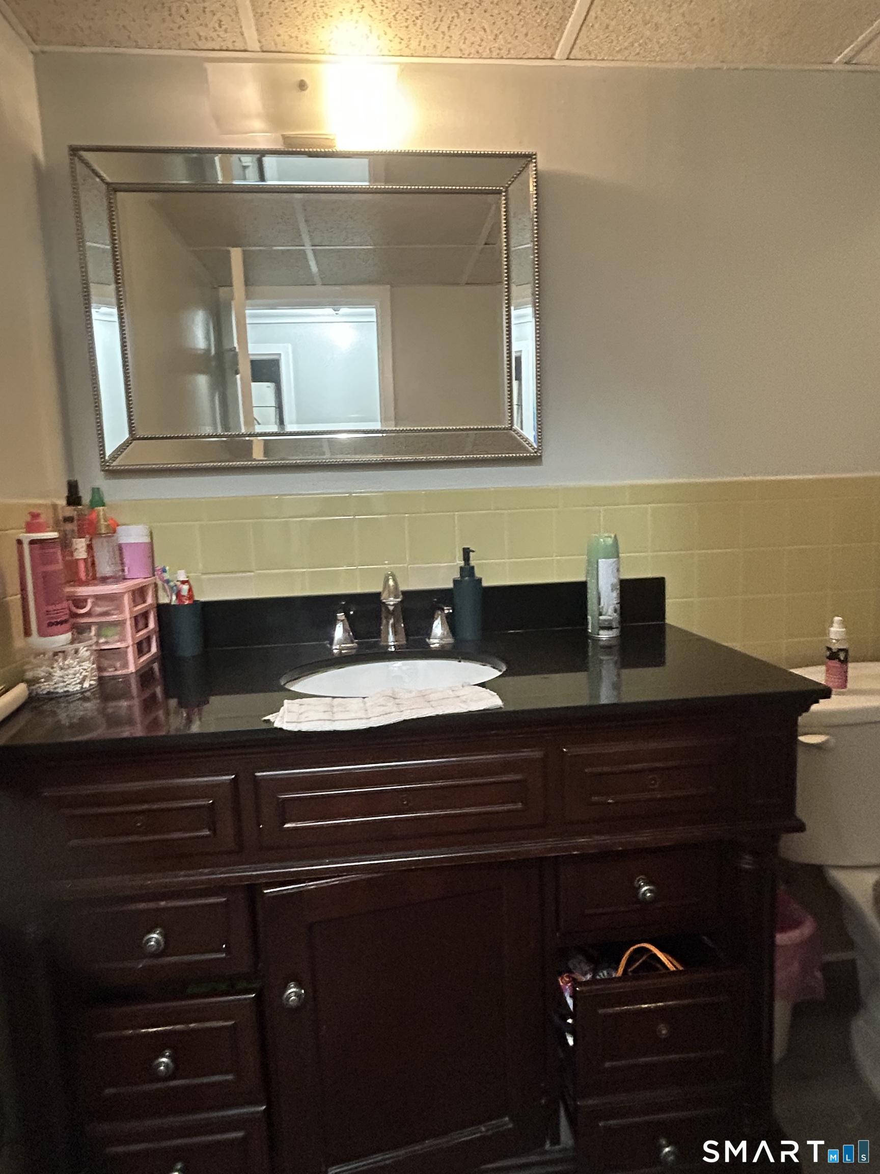 126 Triangle Street, Unit B13 Danbury, CT 06810 - Photo 20 of 20 a bathroom with a sink and a mirror