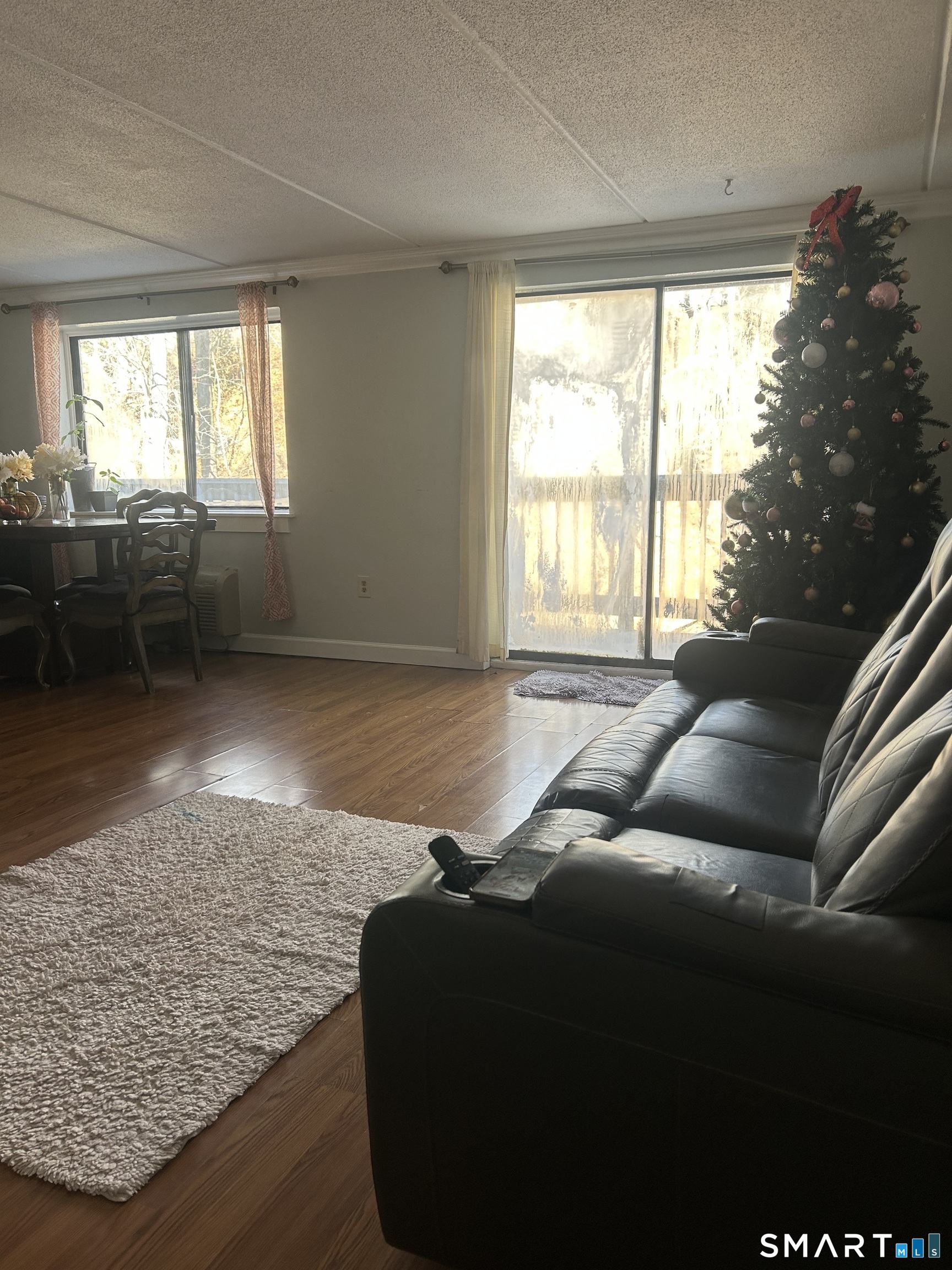 126 Triangle Street, Unit B13 Danbury, CT 06810 - Photo 2 of 20 a living room with furniture and a floor to ceiling window