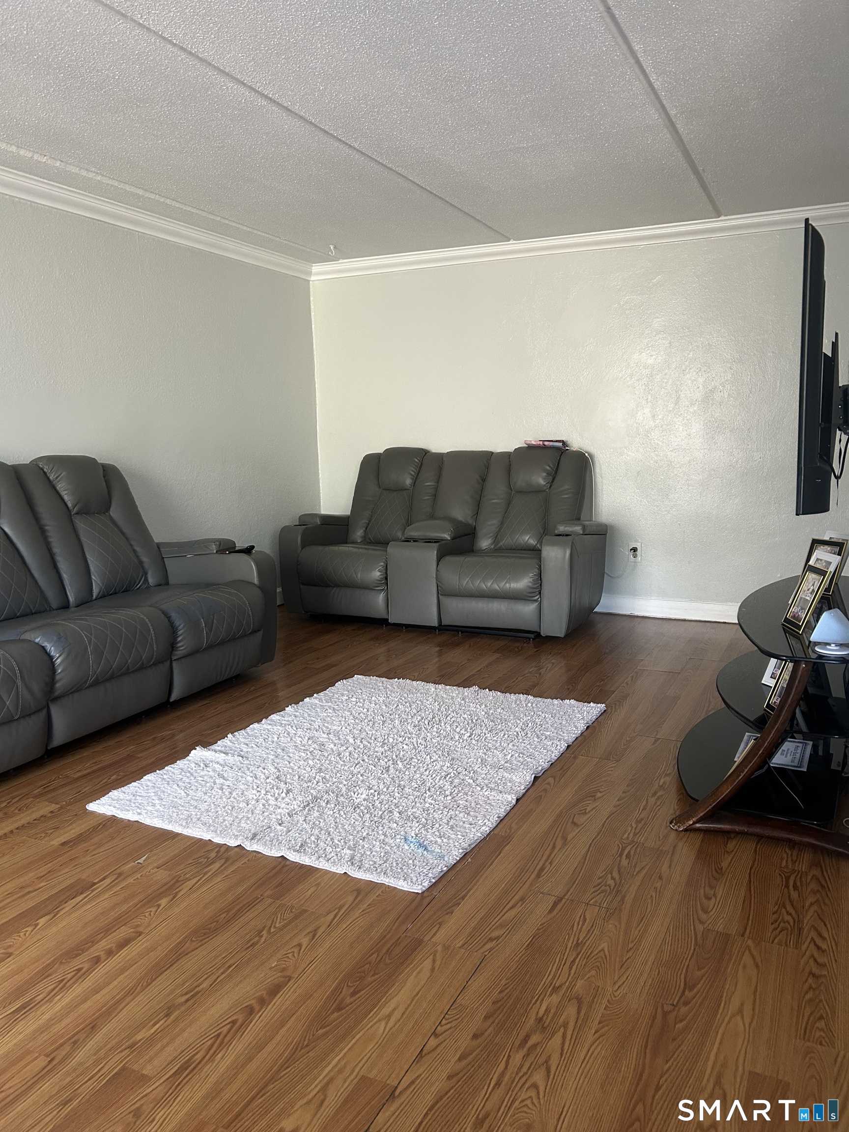 126 Triangle Street, Unit B13 Danbury, CT 06810 - Photo 3 of 20 a living room with furniture and a flat screen tv