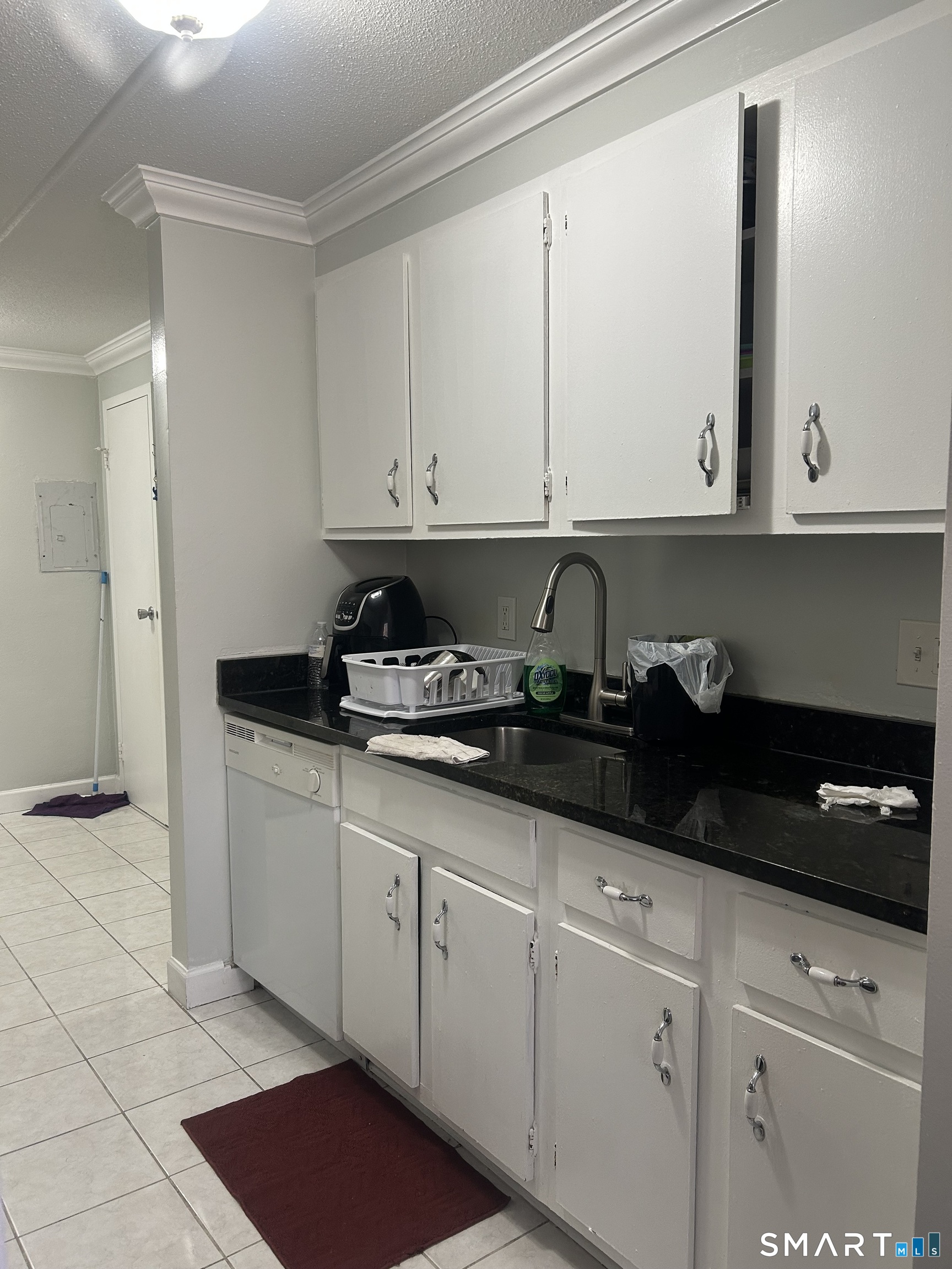 126 Triangle Street, Unit B13 Danbury, CT 06810 - Photo 7 of 20 a kitchen with granite countertop white cabinets and sink