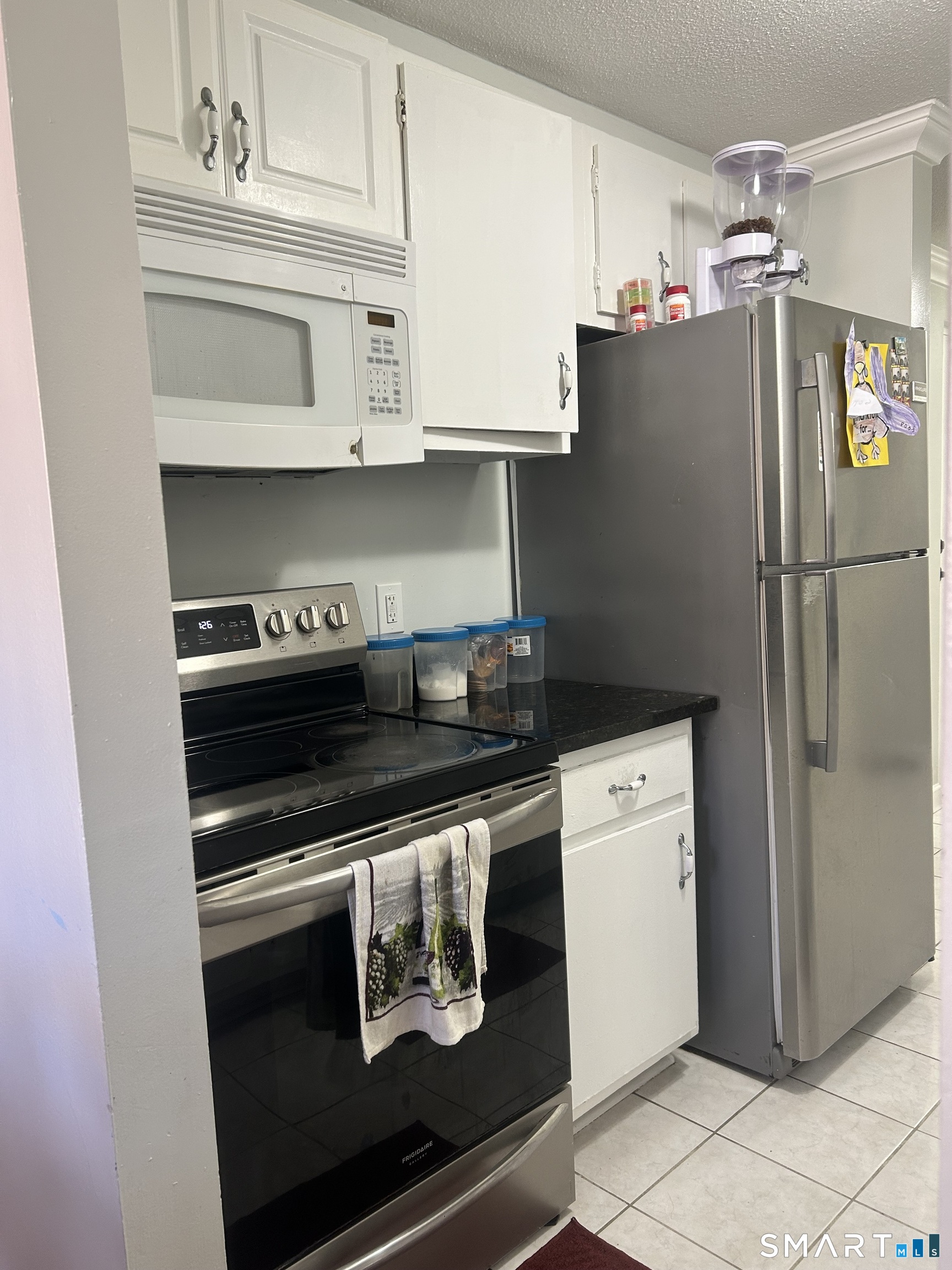 126 Triangle Street, Unit B13 Danbury, CT 06810 - Photo 8 of 20 a kitchen with stainless steel appliances a stove and a refrigerator