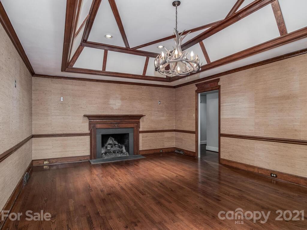 2930 Wickersham Road Charlotte, NC 28211 - Photo 11 of 25 a view of an empty room with wooden floor fireplace and a window