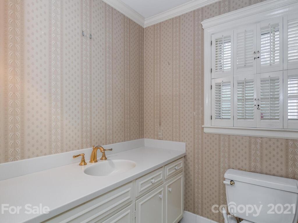 2930 Wickersham Road Charlotte, NC 28211 - Photo 13 of 25 a bathroom with a sink a toilet and a window