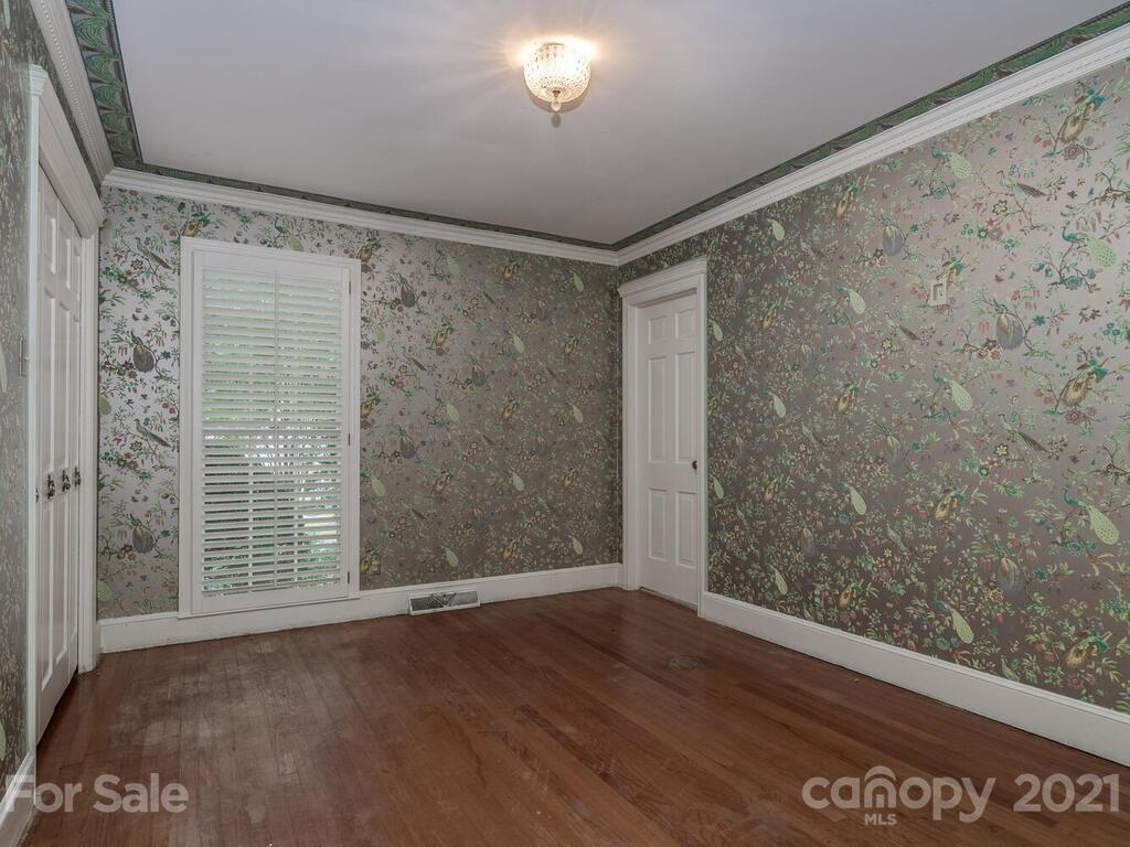 2930 Wickersham Road Charlotte, NC 28211 - Photo 15 of 25 a view of an empty room with wooden floor and a window