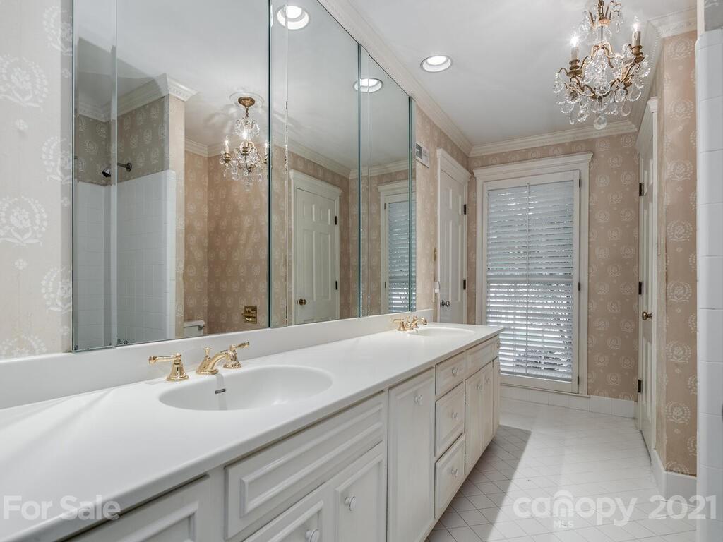 2930 Wickersham Road Charlotte, NC 28211 - Photo 17 of 25 a bathroom with a double vanity sink a large mirror and a shower