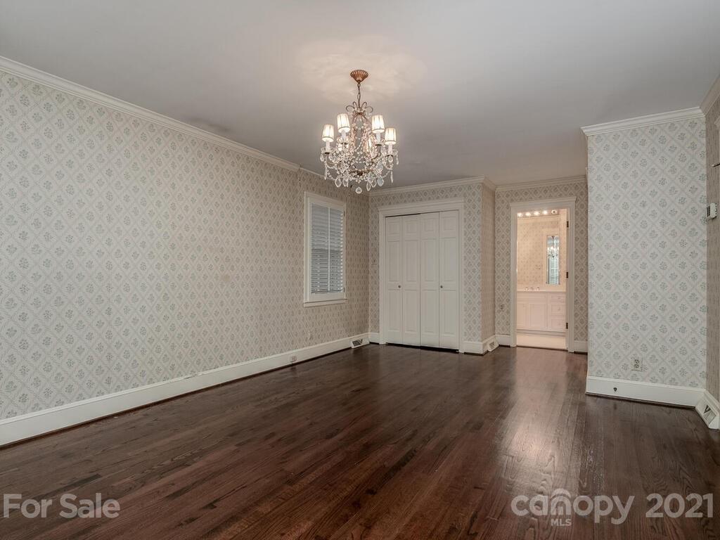2930 Wickersham Road Charlotte, NC 28211 - Photo 19 of 25 a view of an empty room with wooden floor and a window