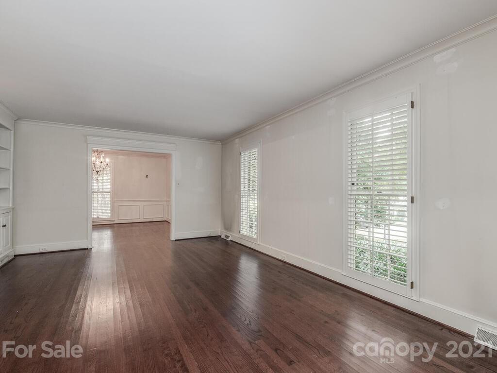 2930 Wickersham Road Charlotte, NC 28211 - Photo 3 of 25 a view of an empty room with wooden floor and a window