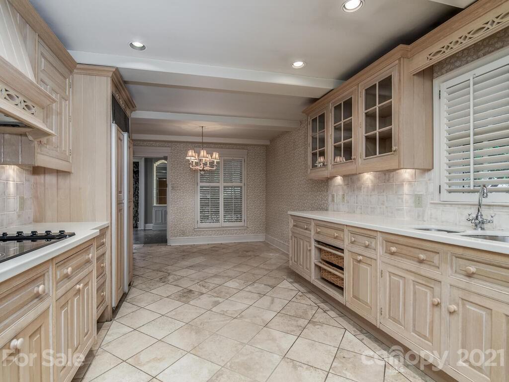 2930 Wickersham Road Charlotte, NC 28211 - Photo 7 of 25 a kitchen with granite countertop a stove and cabinets