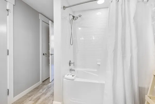 a bathroom with a sink a shower curtain and a shower