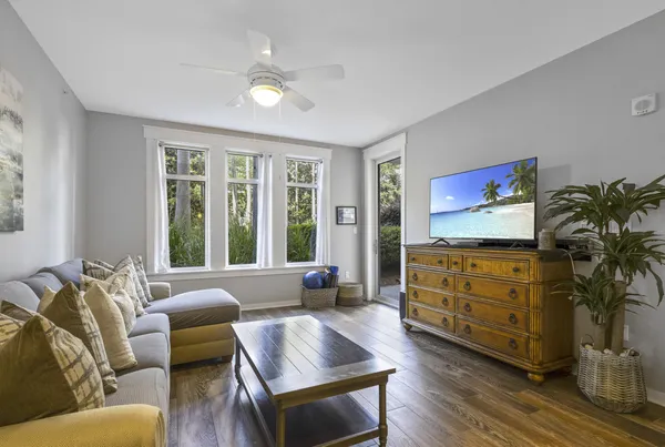 a living room with furniture cabinets and a window