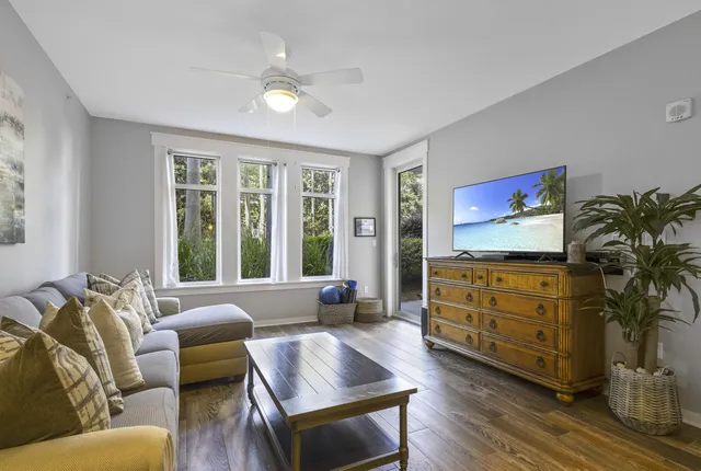a living room with furniture cabinets and a window