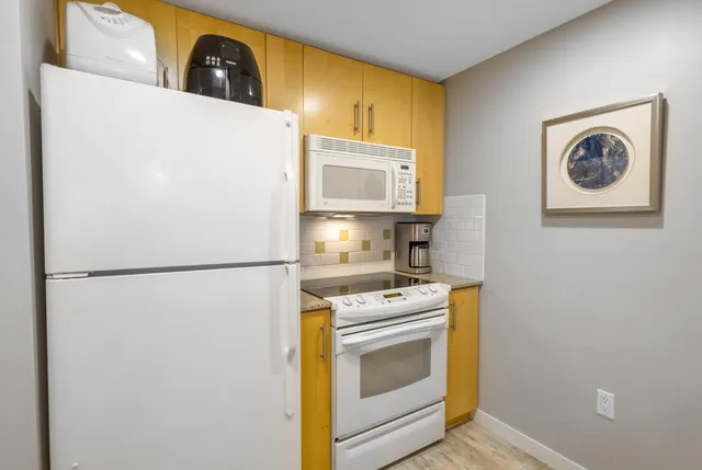 a white refrigerator freezer sitting inside of a kitchen