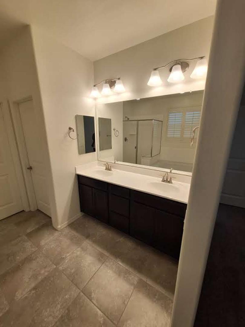 18541 West Mescal Street Surprise, AZ 85388 - Photo 21 of 31 a bathroom with a double vanity sink mirror and bathtub