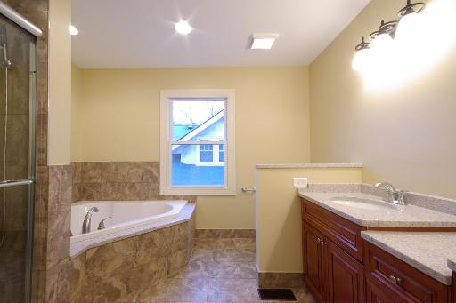 327 Bartram Road Riverside, IL 60546 - Photo 11 of 16 a bathroom with a granite countertop tub sink and mirror
