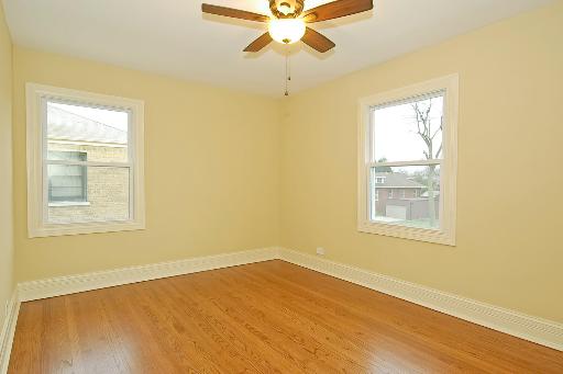 327 Bartram Road Riverside, IL 60546 - Photo 12 of 16 a view of an empty room with a window and wooden floor