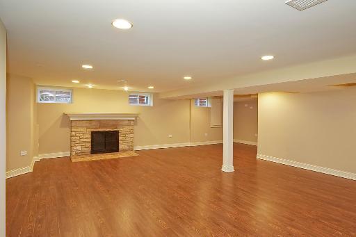 327 Bartram Road Riverside, IL 60546 - Photo 15 of 16 a view of empty room with wooden floor and fireplace