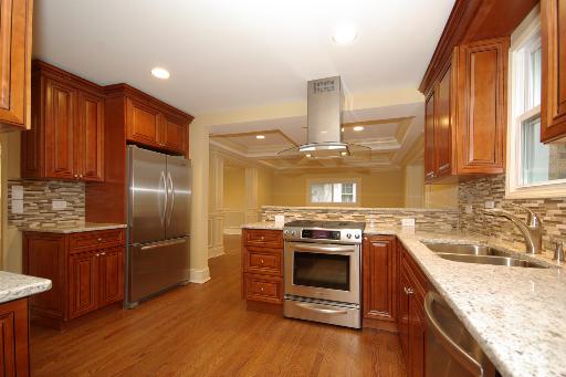 327 Bartram Road Riverside, IL 60546 - Photo 5 of 16 a kitchen with stainless steel appliances granite countertop a sink a stove and a refrigerator
