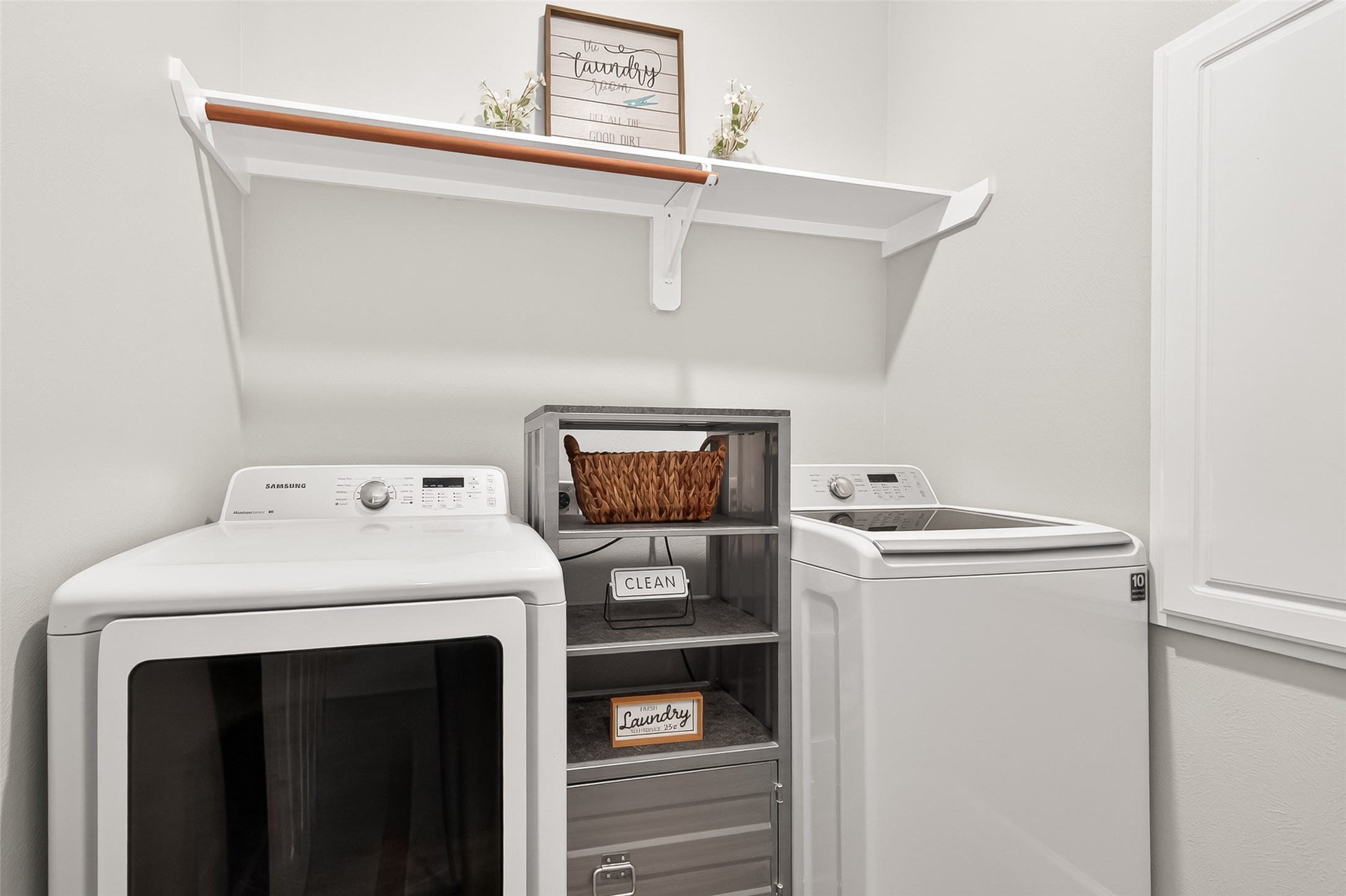 7415 Riven Oaks Court Cypress, TX 77433 - Photo 8 of 42 Spacious laundry room featuring ample shelving, convenient hanging space, and a functional layout designed for everyday organization and efficiency.