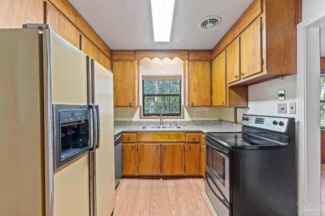 a kitchen with a refrigerator and a sink