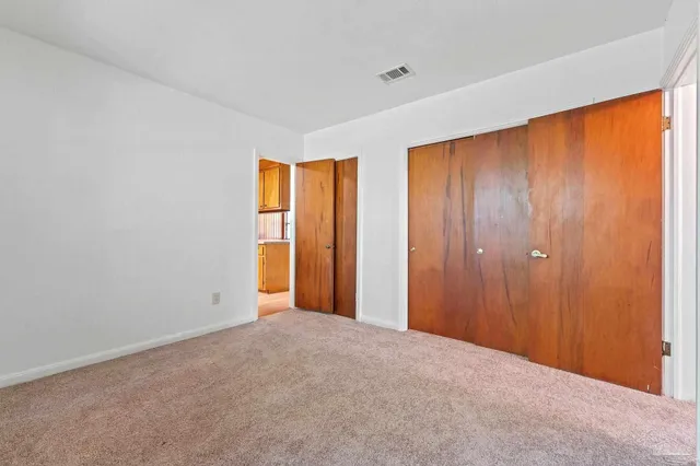 an empty room that has a mirror in it