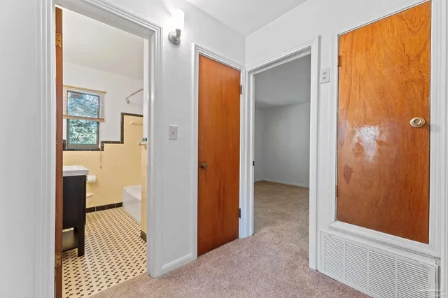 a bathroom with a sink a toilet a mirror and shower