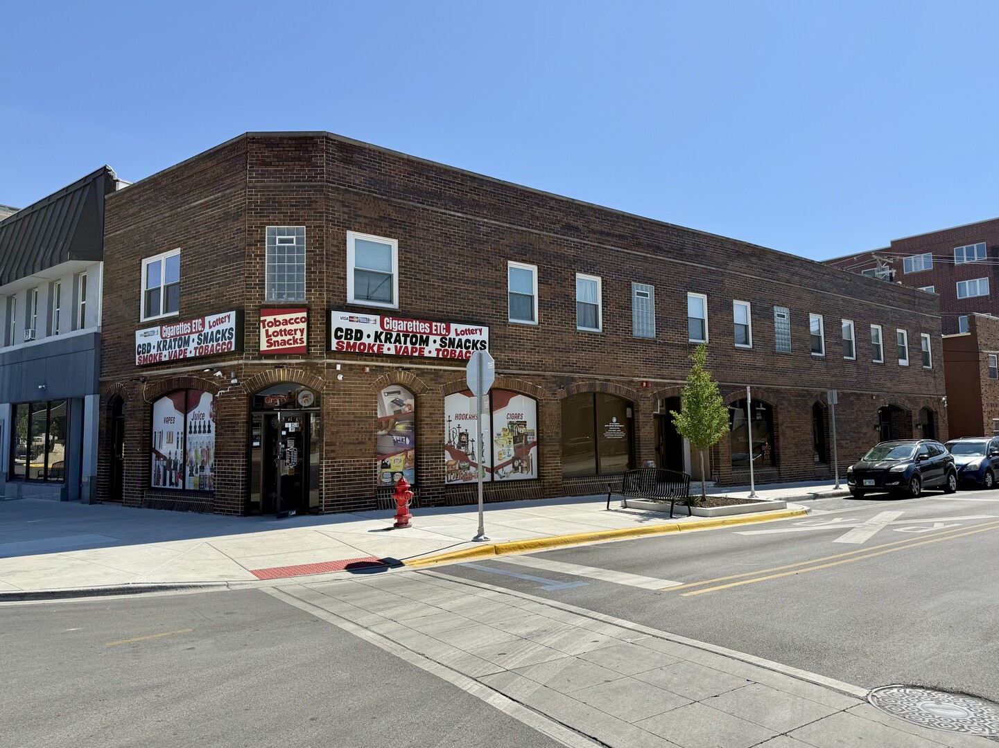 a front view of building with cars