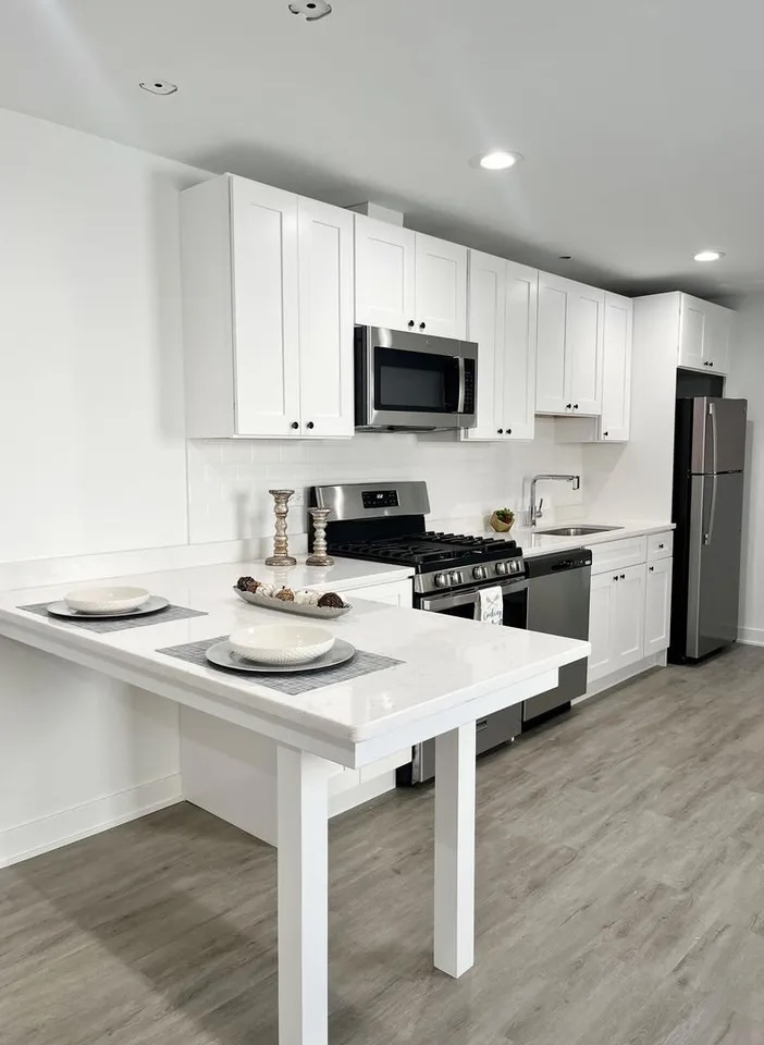 3239 Grove Avenue Berwyn, IL 60402 - Photo 5 of 16 a kitchen with a sink a stove a refrigerator and white cabinets with wooden floor