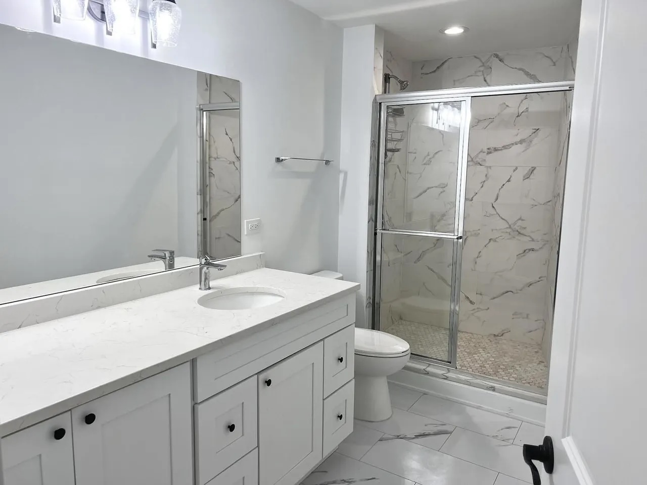 3239 Grove Avenue Berwyn, IL 60402 - Photo 7 of 16 a bathroom with a granite countertop sink a toilet and shower