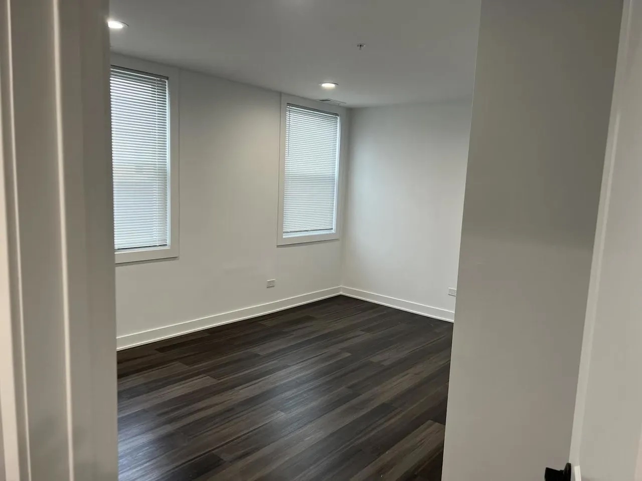 3239 Grove Avenue Berwyn, IL 60402 - Photo 8 of 16 an empty room with wooden floor and windows