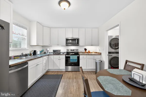 a kitchen with a sink stove and refrigerator