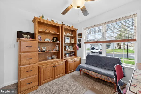 a living room with furniture cabinets and a window