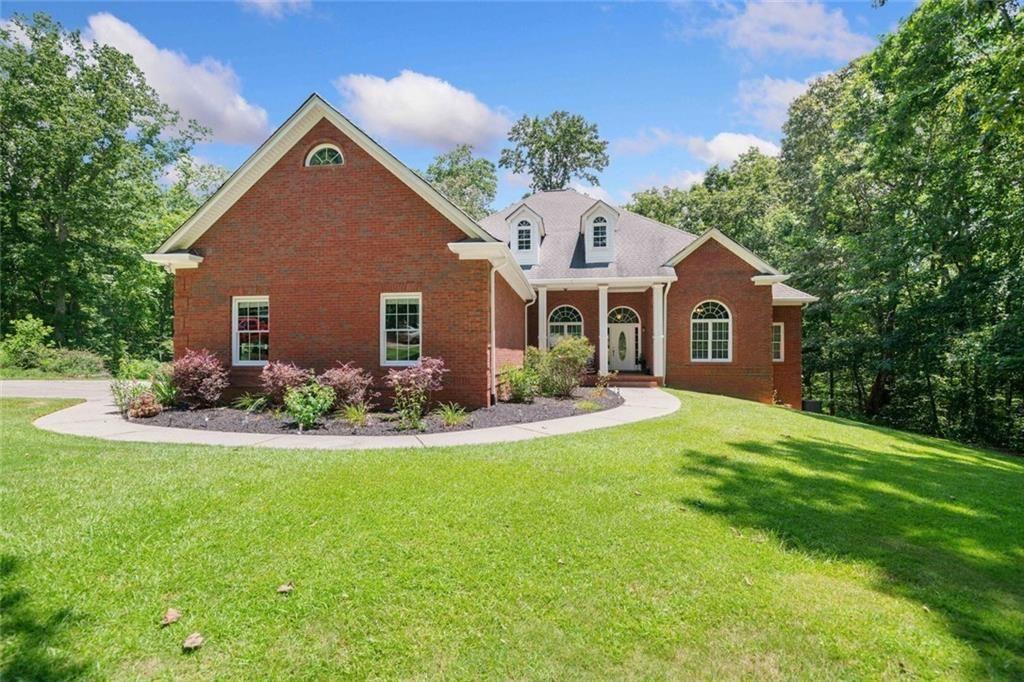 106 Shalea Lane Ball Ground, GA 30107 - Photo 1 of 52 a front view of a house with a yard and garage