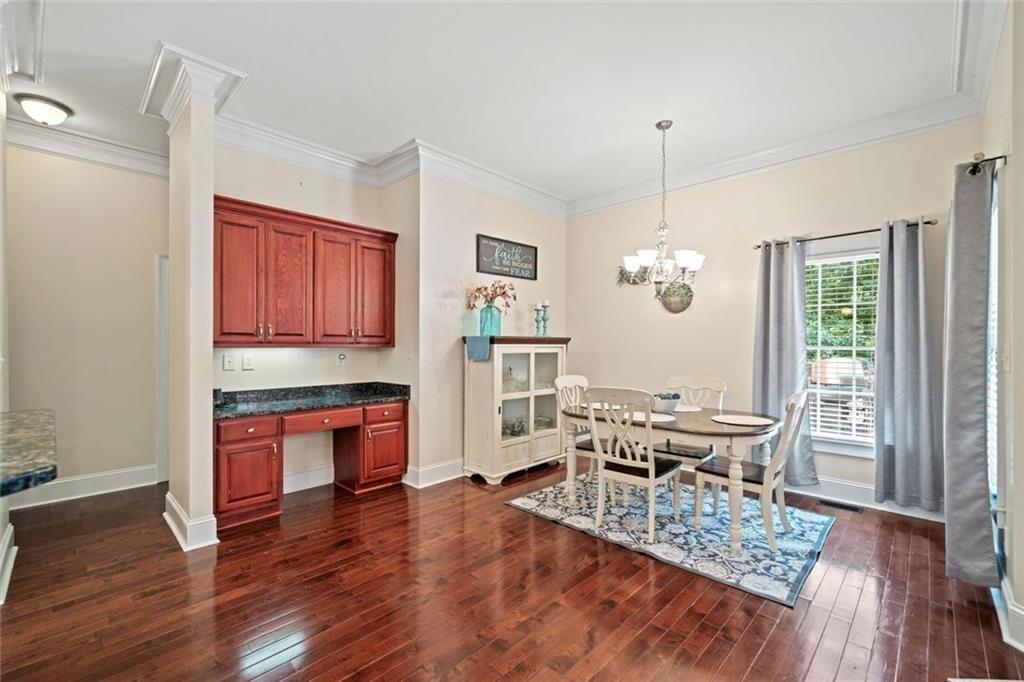 106 Shalea Lane Ball Ground, GA 30107 - Photo 14 of 52 a view of a dining room with furniture a chandelier and wooden floor