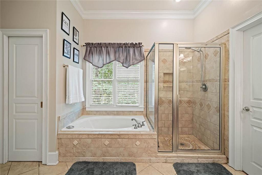 106 Shalea Lane Ball Ground, GA 30107 - Photo 27 of 52 a bathroom with a bathtub and a shower