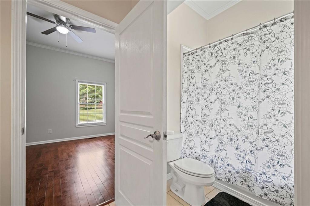 106 Shalea Lane Ball Ground, GA 30107 - Photo 32 of 52 a bathroom with a toilet and a shower curtain