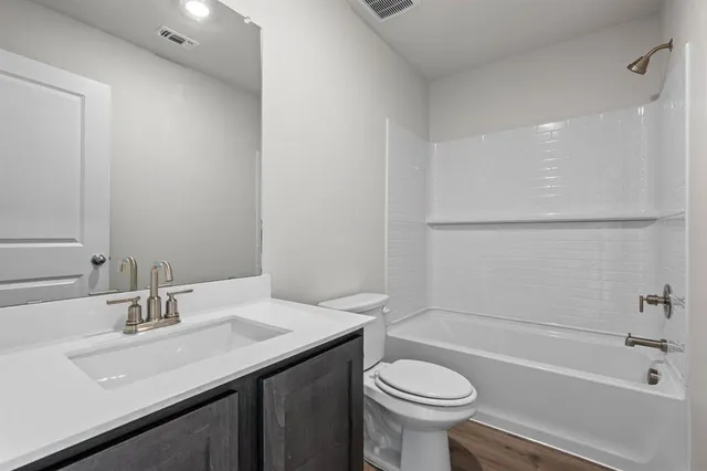 a bathroom with a sink a toilet and a bathtub