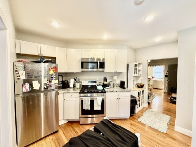 14 Cleveland Place, Unit 3 Boston, MA 02113 - Photo 1 of 22 a kitchen with stainless steel appliances granite countertop a refrigerator stove microwave and sink