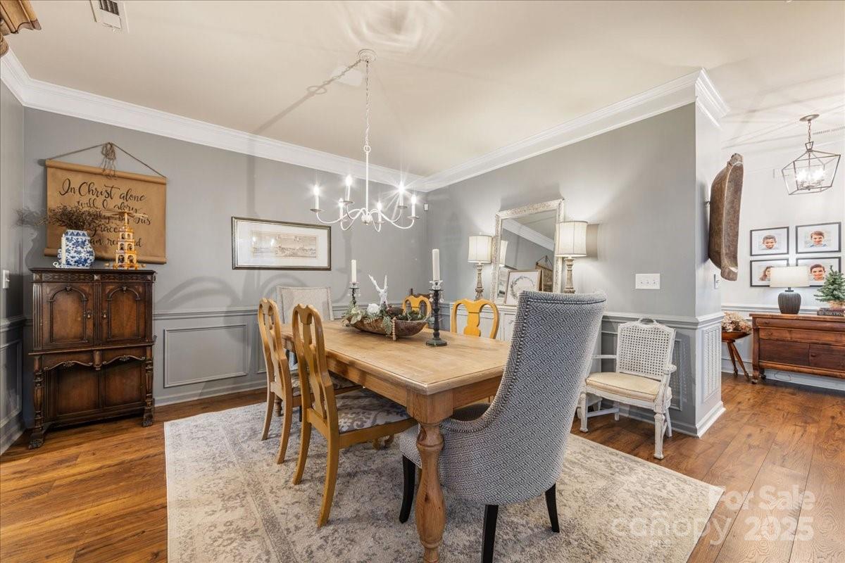 718 Deerbrook Lane Tega Cay, SC 29708 - Photo 12 of 45 a dining room with furniture a chandelier and wooden floor