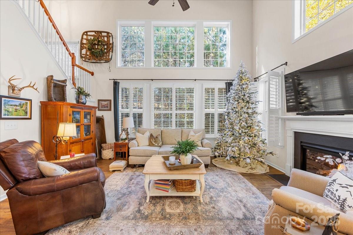 718 Deerbrook Lane Tega Cay, SC 29708 - Photo 18 of 45 a living room with furniture a flat screen tv and a fireplace